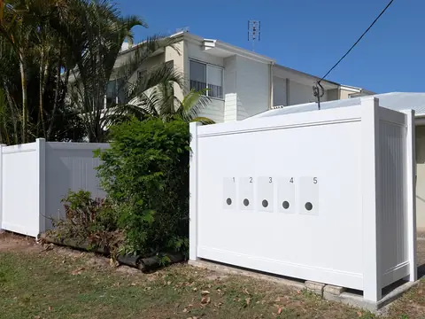 White solid wall panel fence along a front garden