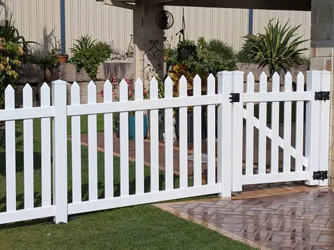 White PVC picket fence and gate in a front garden